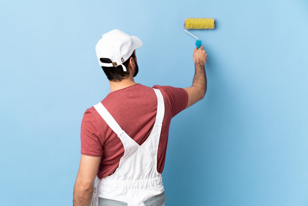 painter man over isolated blue wall